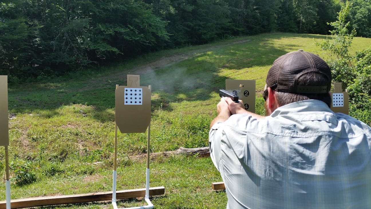 A student hones marksmanship skills by shooting 1" bullseyes